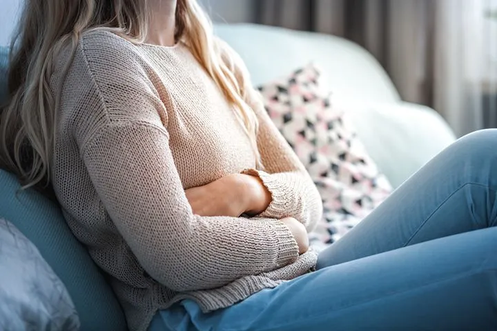 Woman experiencing abdominal discomfort associated with IBS